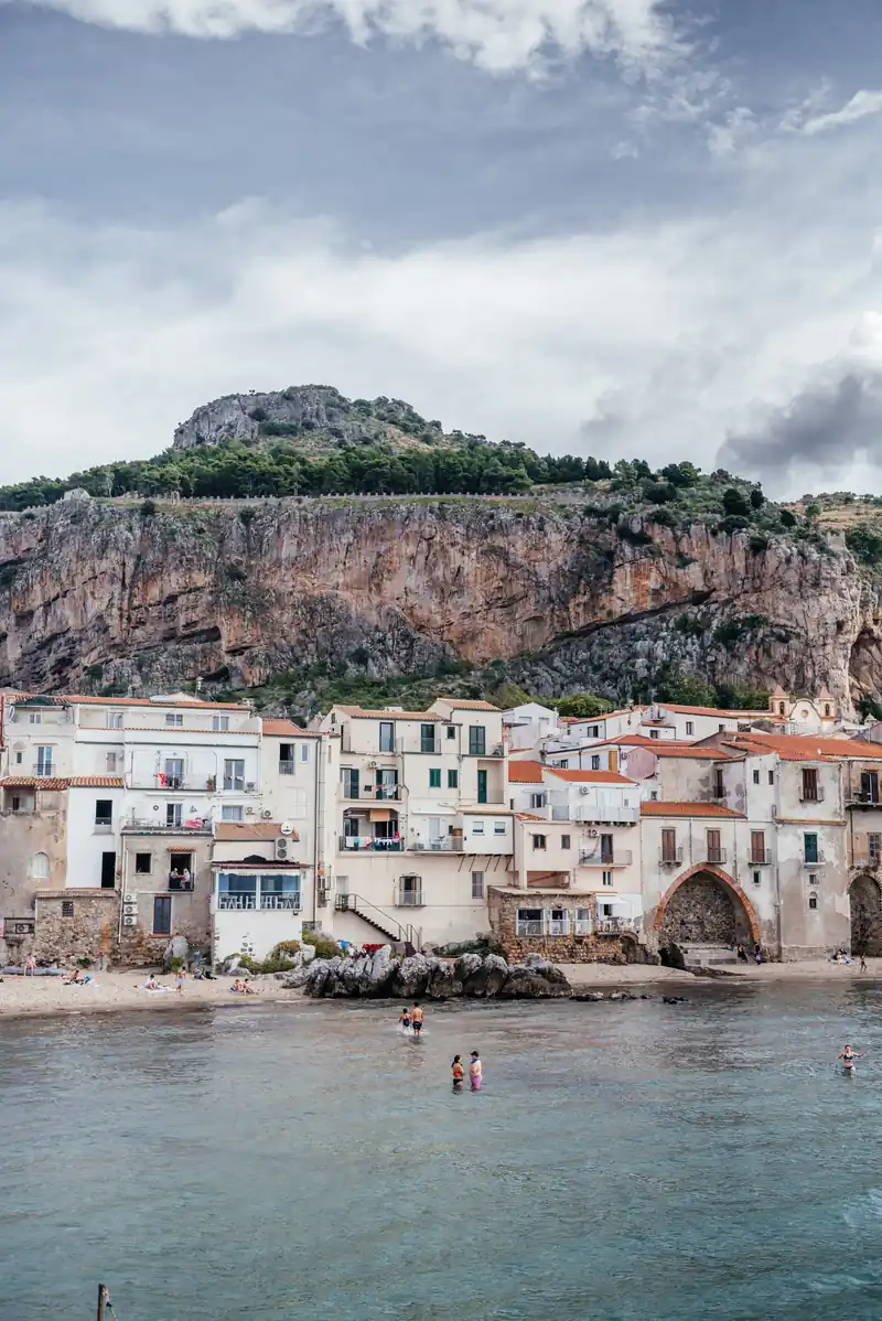 Cefalù's houses clustered below the sheer face of La Rocca