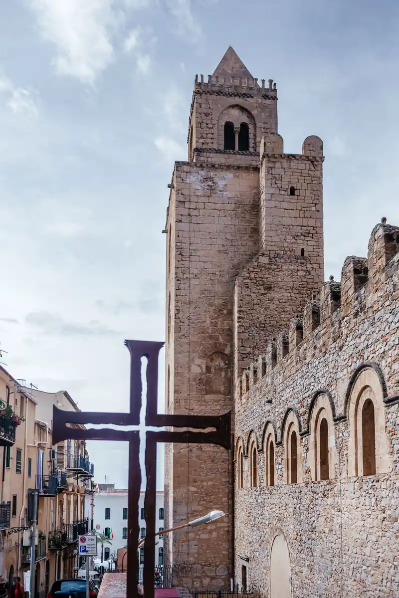 A medieval stone tower in Cefalù's historic centre