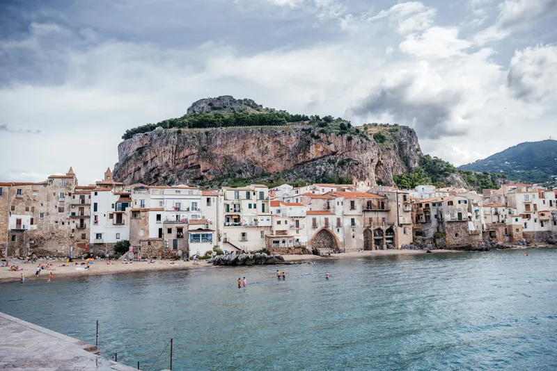 Panorama of Cefalù old town and harbour beneath La Rocca