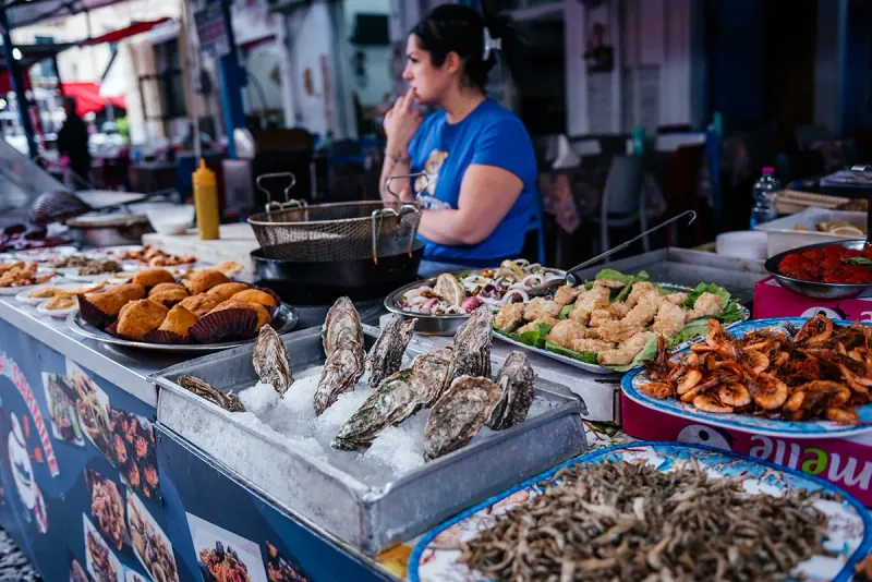 A Palermo street food market stall piled with Sicilian specialities